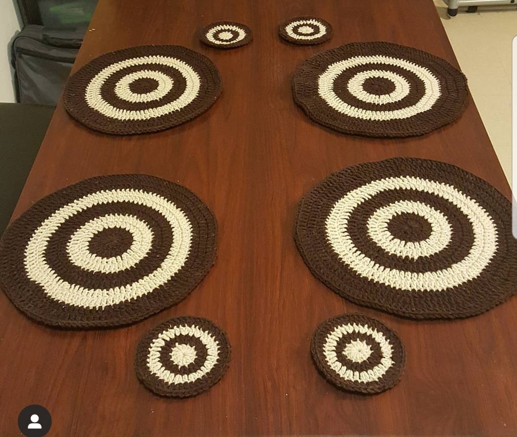 Crocheted round placemats and matching drink coasters. [Set of 4.]